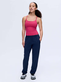 Model wearing Zephyr 29" Pant in Navy, with lightweight fabric and zippered pockets.
