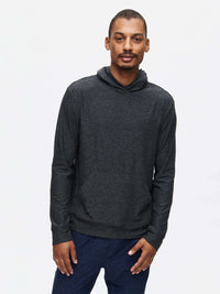 Model wearing a CloudKnit Hoodie in dark grey, featuring a large kangaroo pocket and a lightweight design.