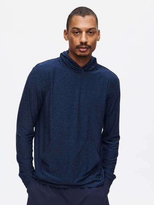 Model wearing a stylish navy CloudKnit Hoodie, featuring a cozy design and breathable fabric for comfort.