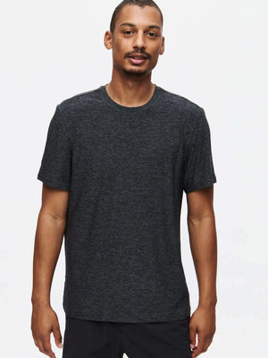 Man wearing a comfortable CloudKnit Shortsleeve t-shirt in dark gray, perfect for everyday low-sweat activities.