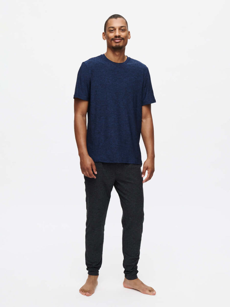 Man wearing CloudKnit Shortsleeve t-shirt with comfortable pants, showcasing soft, lightweight design.