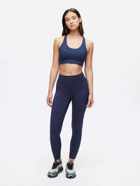 Model showcasing the Doing Things Bra with matching leggings in navy, perfect for high-performance workouts.