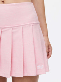 Doing Things 3" Skort in pink with pleats and OV's signature logo on the side.