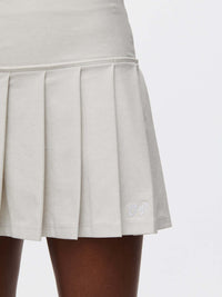 Doing Things 3" Skort featuring a pleated design with OV logo and textured compression fabric.