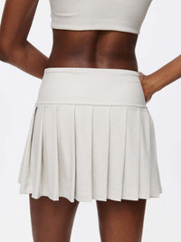 Doing Things 3" Skort showing pleated design and built-in shorts in a stylish light gray fabric.