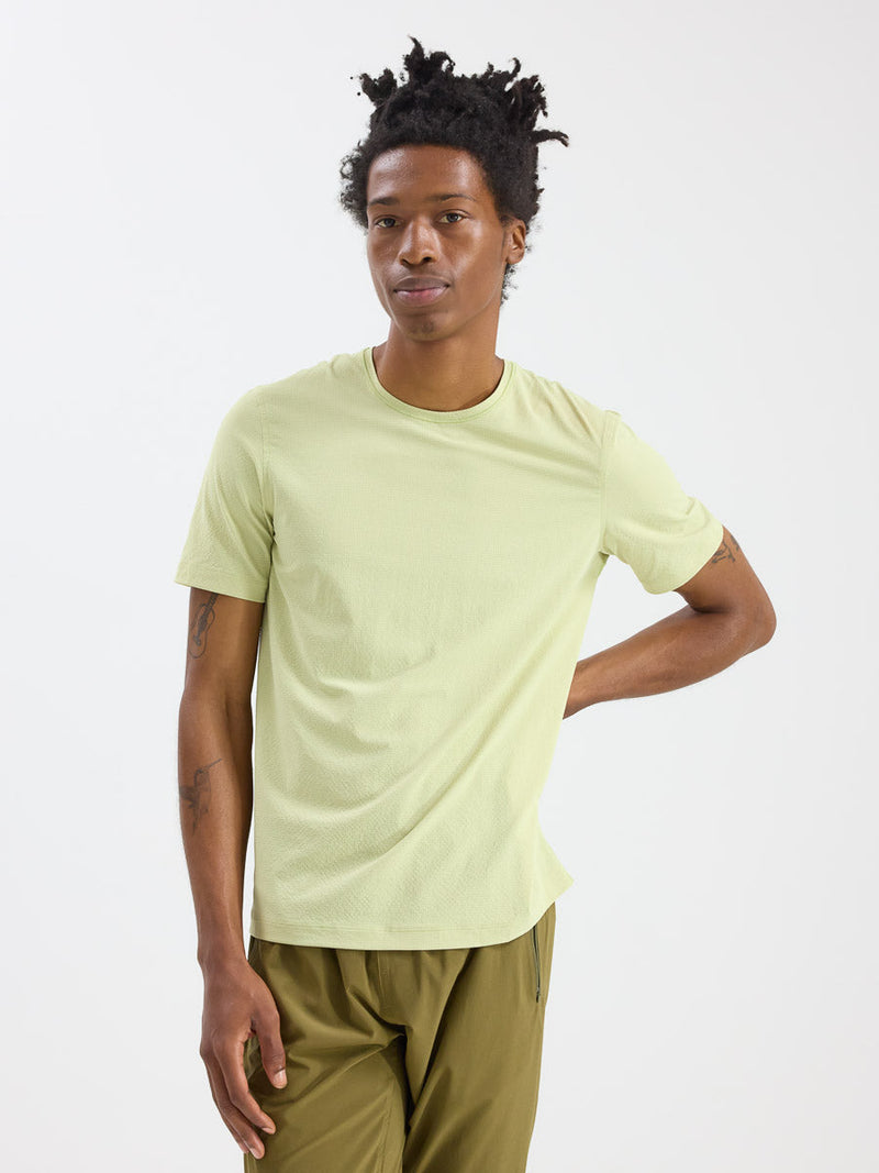 a person wearing a light yellow shirt