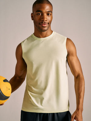 A man wearing a yellow tank top