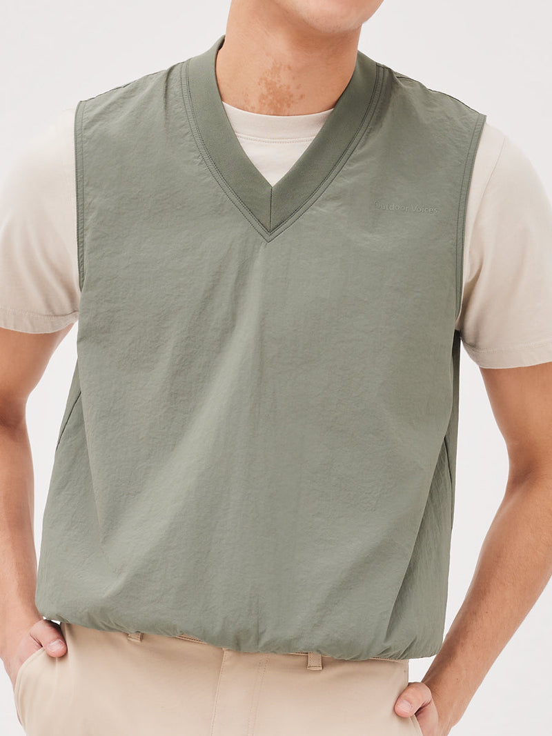 a person wearing a green vest