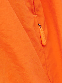 a person wearing an orange jacket