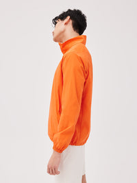 a person wearing an orange jacket
