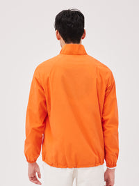 a person wearing an orange jacket