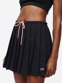 Stardust Skirt featuring pleats, side zipper, drawstring tie, and hand-embroidered OV logo.