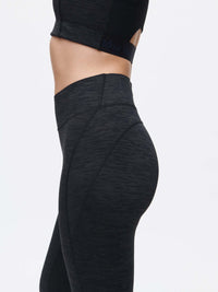 Woman showcasing TechSweat Core 7/8 Legging, perfect for high sweat activities with a secure waistband.