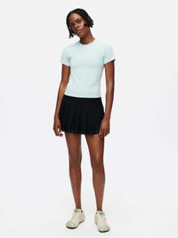 Model wearing a light blue ThinkFast Jersey Baby Tee with a black skirt, showcasing its soft and breathable design.