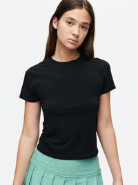 Model wearing ThinkFast Jersey Baby Tee in black, showcasing its soft and breathable fabric.