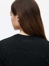 Back view of a model wearing the ThinkFast Jersey Baby Tee showcasing its soft fabric and stylish design.