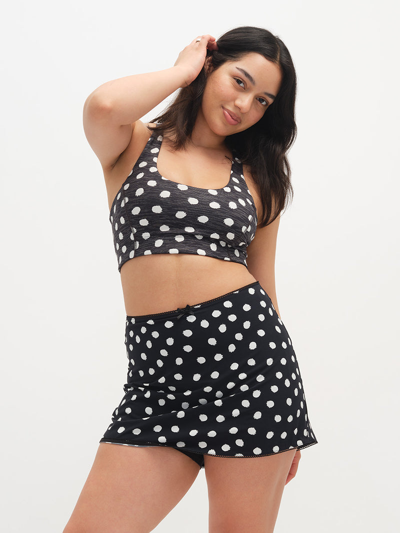Woman wearing a black polka dot set on a white background