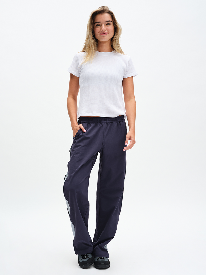 Waffle Baby Tee in White – front full-length view styled with navy track pants
