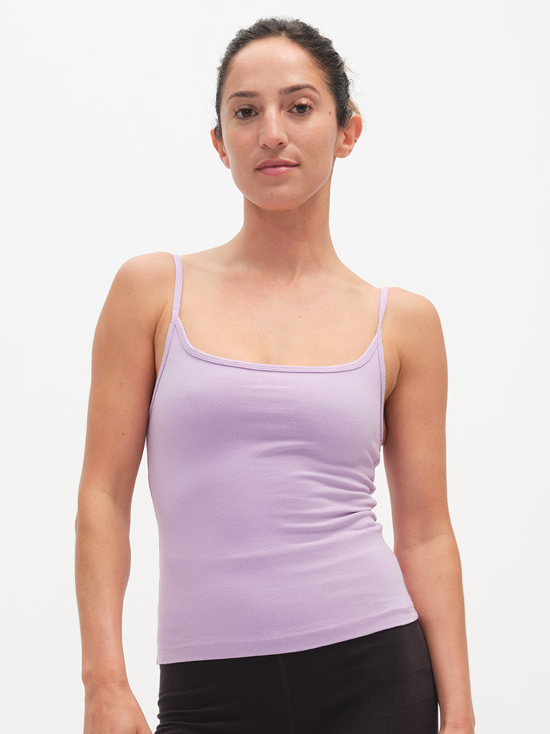 Woman wearing a light purple tank top against a white background