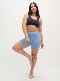 Model posing in Double Dip Bra in Navy, featuring a double scoop neckline and wide shoulder straps.