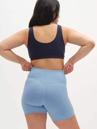 Back view of model wearing Double Dip Bra in Navy, showing wide shoulder straps and supportive fit.