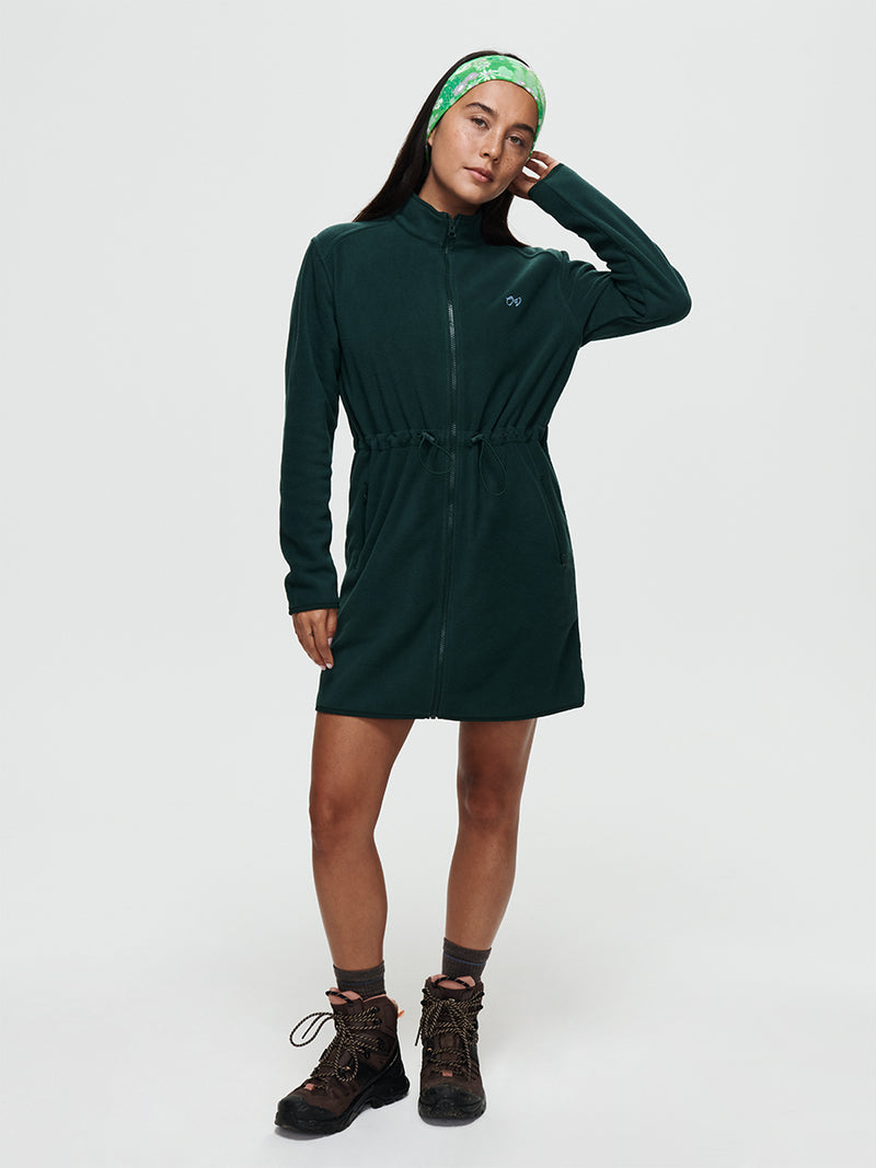Boulder Dress in green, featuring a full-zip design, adjustable waist toggles, and front pockets.