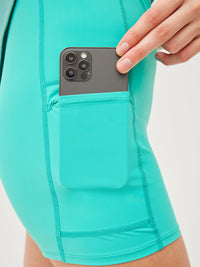 a person wearing a turquoise dress