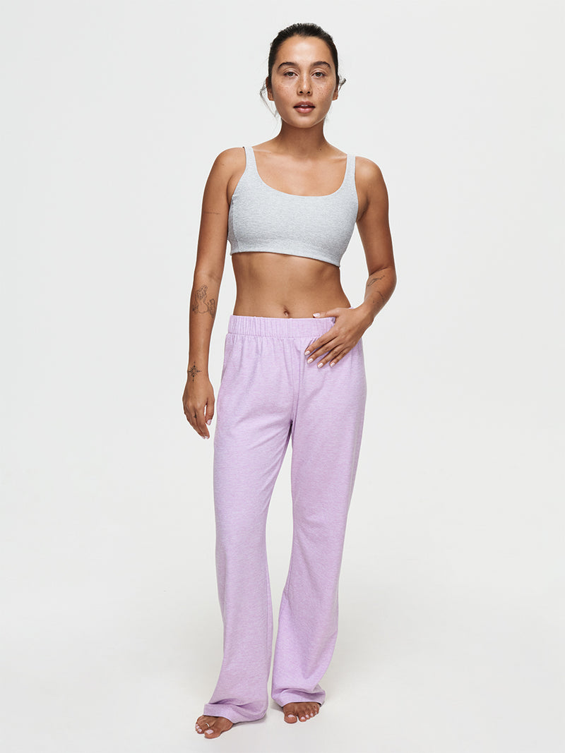 Model wearing CloudKnit Wide Leg Pant in lavender with a grey crop top, highlighting comfort and style.