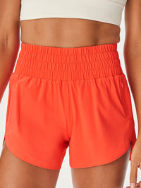 a person wearing coral shorts