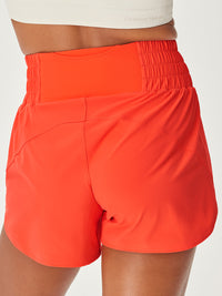 a person wearing coral shorts