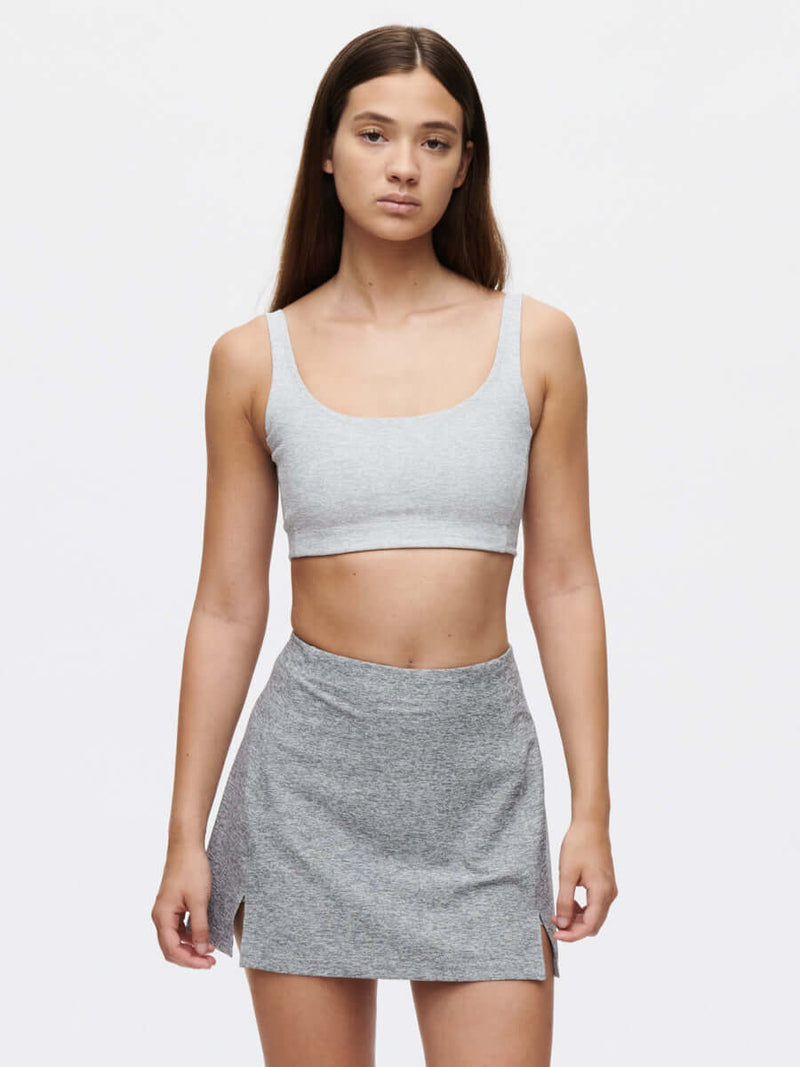 Model wearing the Warmup 2.5" Skort CL paired with a matching grey crop top.