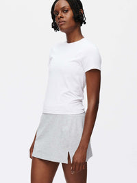 Model showcasing the Warmup 2.5" Skort, made from textured compression fabric for performance and comfort.