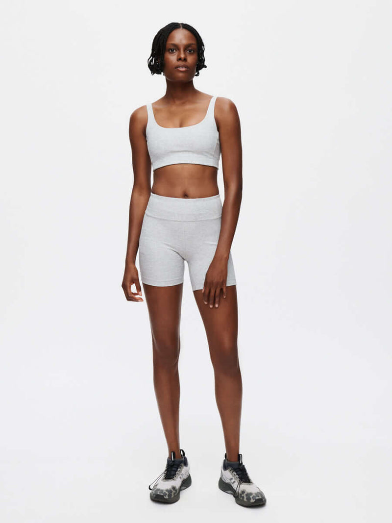 Model wearing a Warmup 5" Short and matching top in textured compression fabric for activewear.