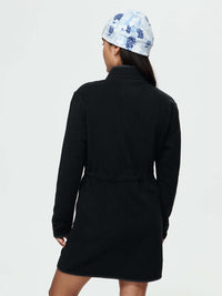 Back view of Boulder Dress in Black with adjustable waist toggles, styled with a light blue patterned hat.
