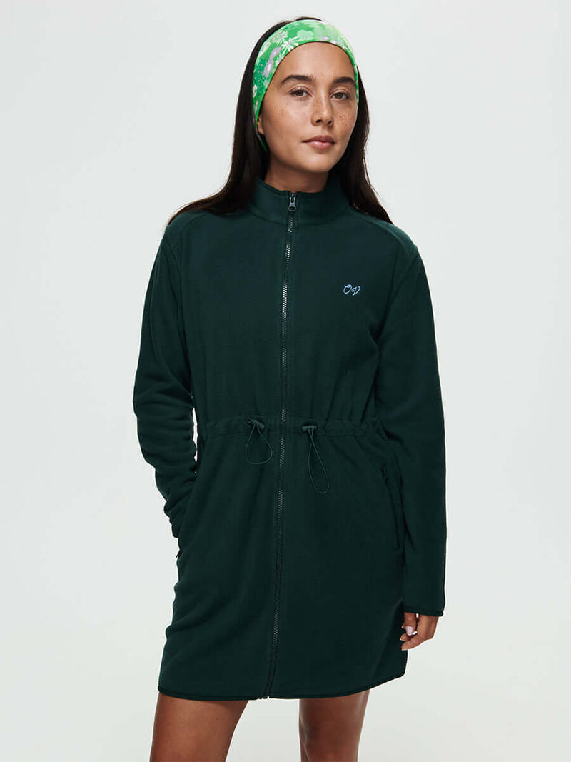 Model wearing Boulder Dress in Forest Green with adjustable waist toggles and full-zip design.
