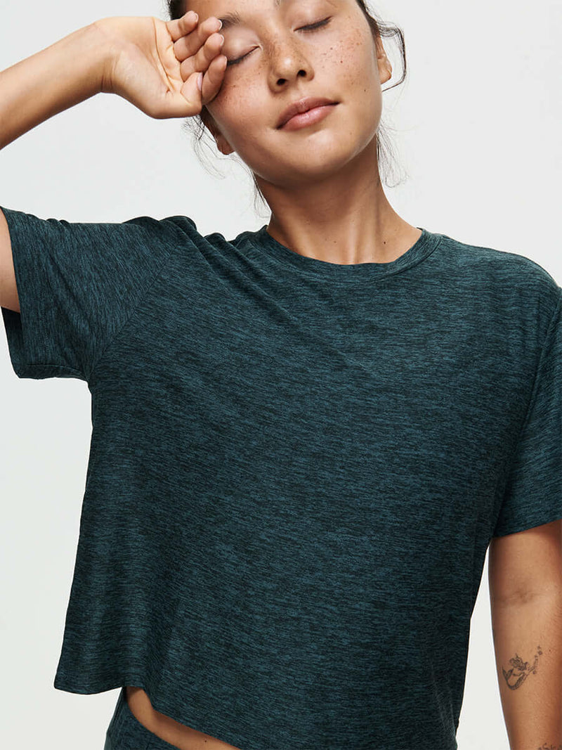 Model wearing the CloudKnit Boxy Shortsleeve shirt, with comfort and style in breathable fabric.