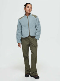 Model wearing Candy Fleece Jacket in Light Blue, featuring a zip front and contrast nylon panels.