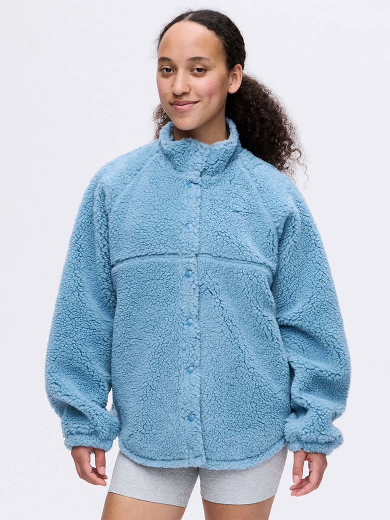 Model wearing Candy Fleece Snap Jacket in Light Blue, featuring a soft fluffy texture and oversized fit.