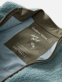 Inside view of Candy Fleece Vest in Light Blue, featuring breathable mesh lining and care label. 