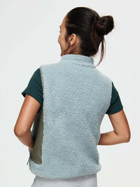 Back view of Candy Fleece Vest in light blue, featuring contrast technical nylon side panels.