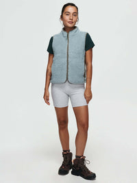 Model standing in Candy Fleece Vest, light blue color, featuring cozy fleece texture and front zipper pockets.