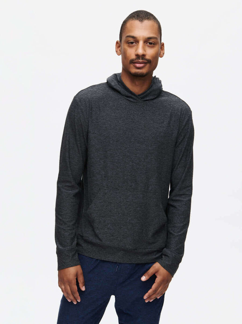 Model wearing CloudKnit Hoodie in dark gray, featuring a spacious kangaroo pocket and lightweight fabric.