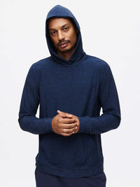 Model wearing CloudKnit Hoodie in navy, soft fabric with a relaxed fit, ready for everyday activities.