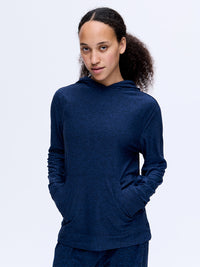 Model wearing CloudKnit Hoodie in Navy, featuring a large kangaroo pocket and soft, breathable fabric.