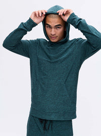 Model pulling the hood of CloudKnit Hoodie in Deep Teal, lightweight and breathable fabric for everyday use.