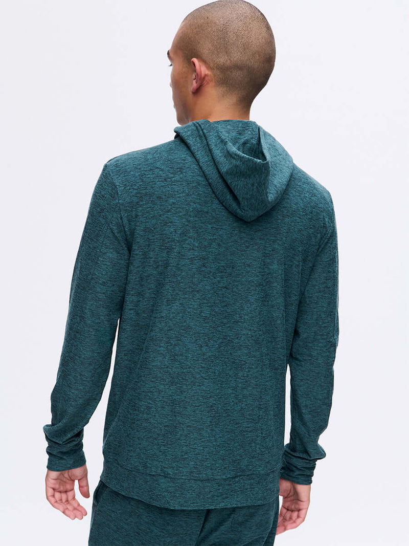 Back view of model wearing CloudKnit Hoodie in Teal with a soft, breathable fabric, for everyday wear.