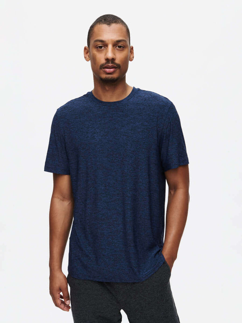 Model standing confidently in CloudKnit Shortsleeve in Navy, with lightweight, breathable fabric.