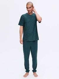 Model posing in CloudKnit Shortsleeve and matching pants, soft, lightweight fabric ideal for lounging.