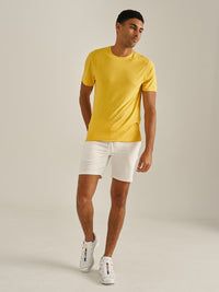 Model walking in CloudKnit Shortsleeve in sunny yellow, soft and lightweight for everyday wear.