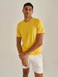 Model wearing CloudKnit Shortsleeve in bright yellow, with lightweight and breathable fabric.